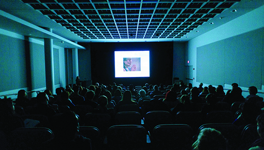 woman presenting at a lecture