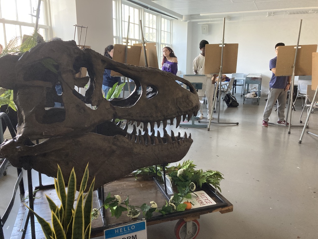 A t-rex skull and students